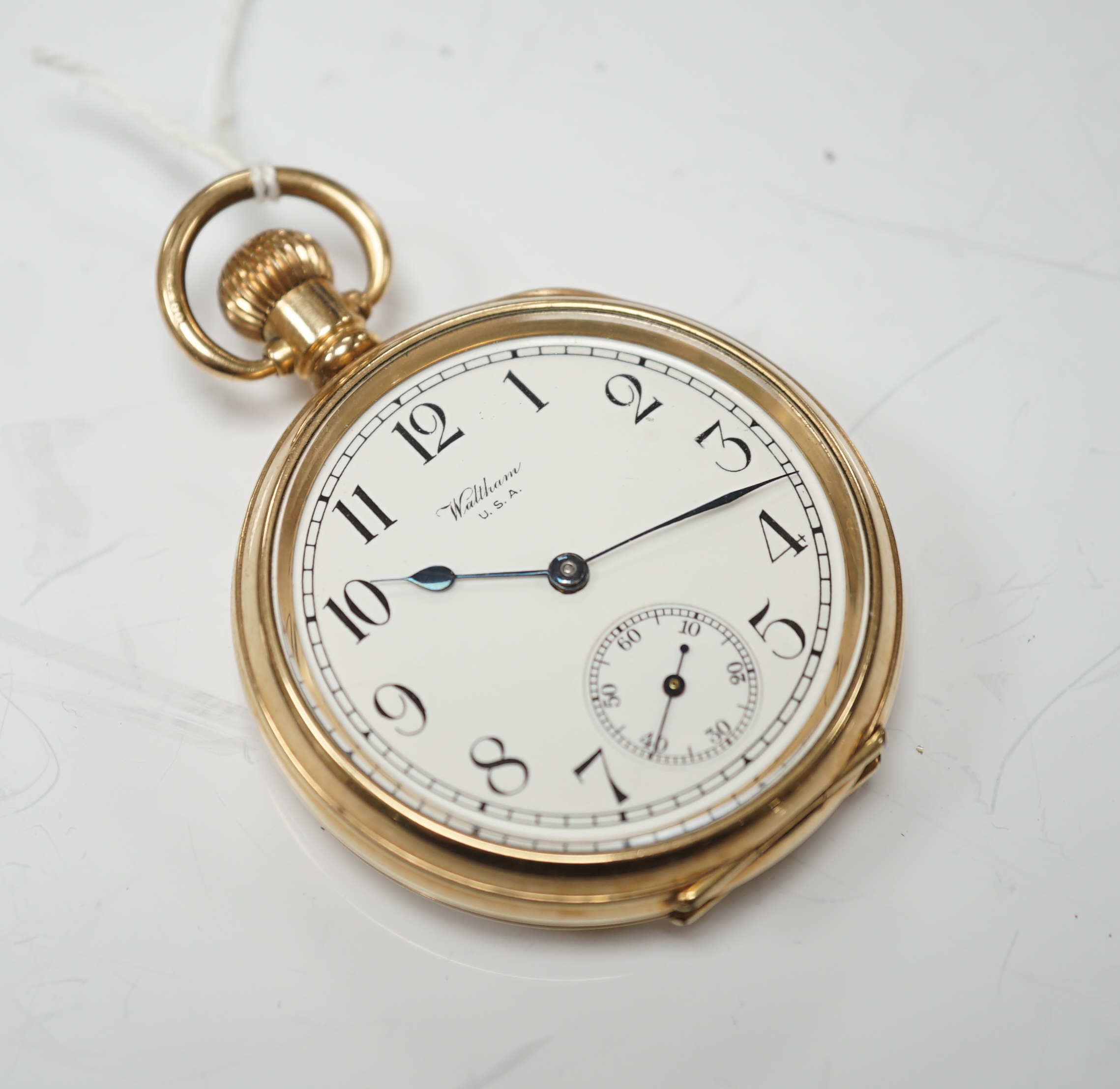 A Waltham gold plated open face keyless pocket watch, with Roman dial and subsidiary seconds.